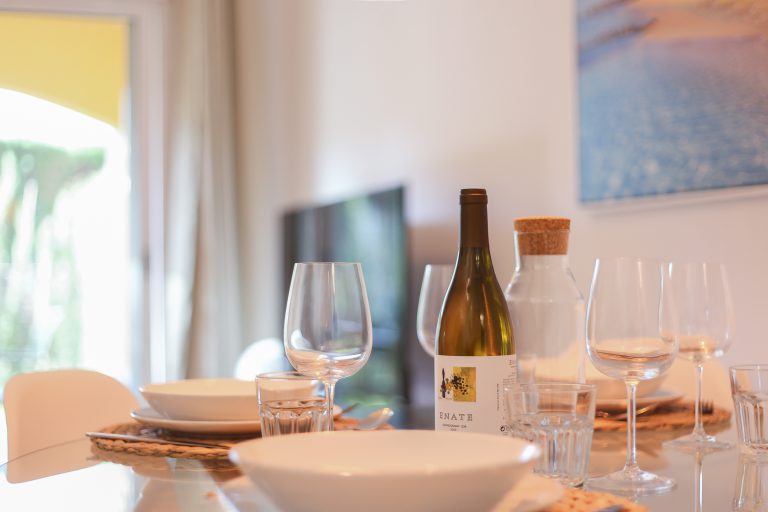 Dining table with tableware at apartment Alquería Sol in Dénia