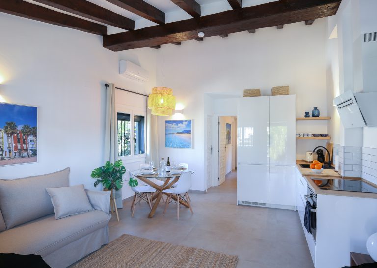 Living room interior with wooden ceiling beams at apartment Montesol in Dénia