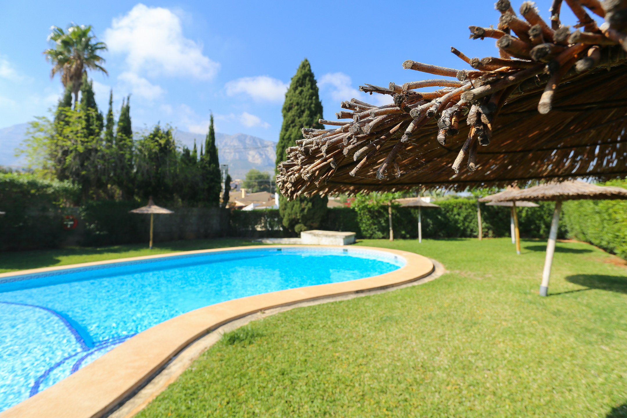 Pool area with sun loungers at apartment Montesol in Dénia