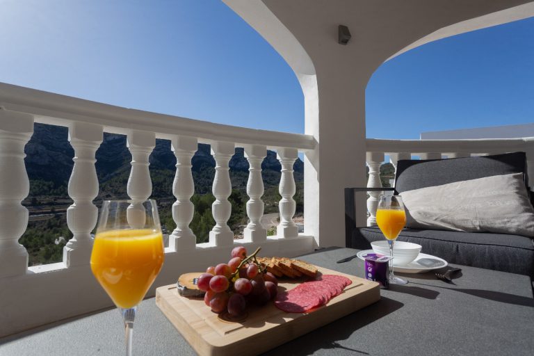 Terrace breakfast table with mountain views at Villa Vino in Pedreguer