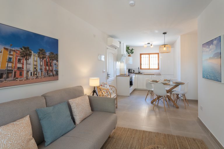 Living room with sofa and terrace door at apartment El Patio in Dénia