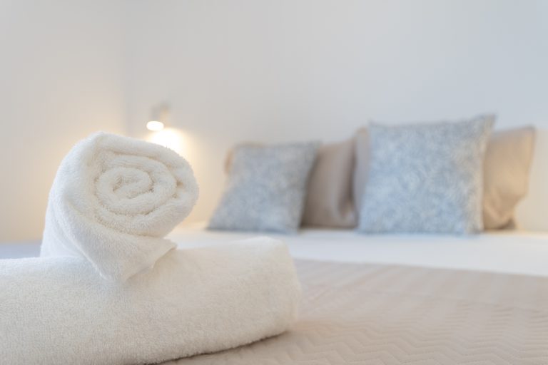 Bedroom with rolled towels at apartment El Patio in Dénia