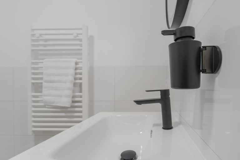 Bathroom with sink and mirror at apartment El Patio in Dénia