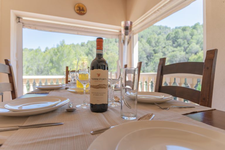 Outdoor dining area with mountain views at Villa Casa Joni in Orba
