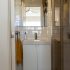 Bathroom with toilet and storage cabinet at apartment Retiro Sol A05 in Dénia