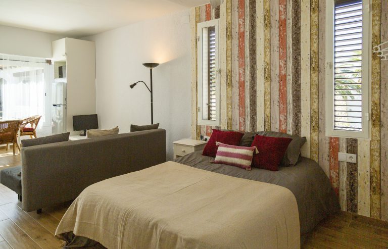 Living room with sofa and bedroom view at apartment Retiro Sol A05 in Dénia