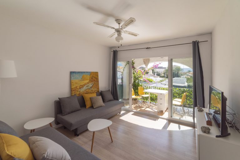 Living area with seating and balcony doors at apartment Retiro Sol A09 in Dénia