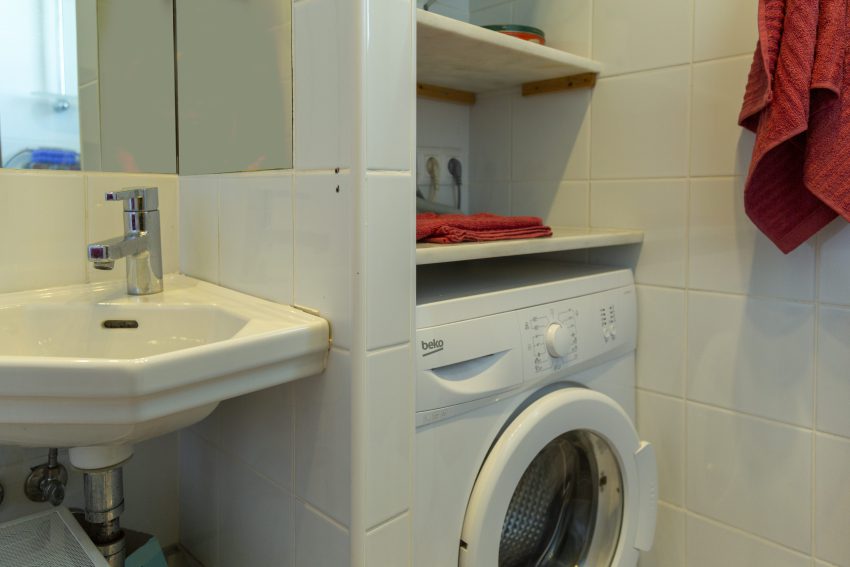Bathroom with sink and washing machine at apartment Retiro Sol A09 in Dénia