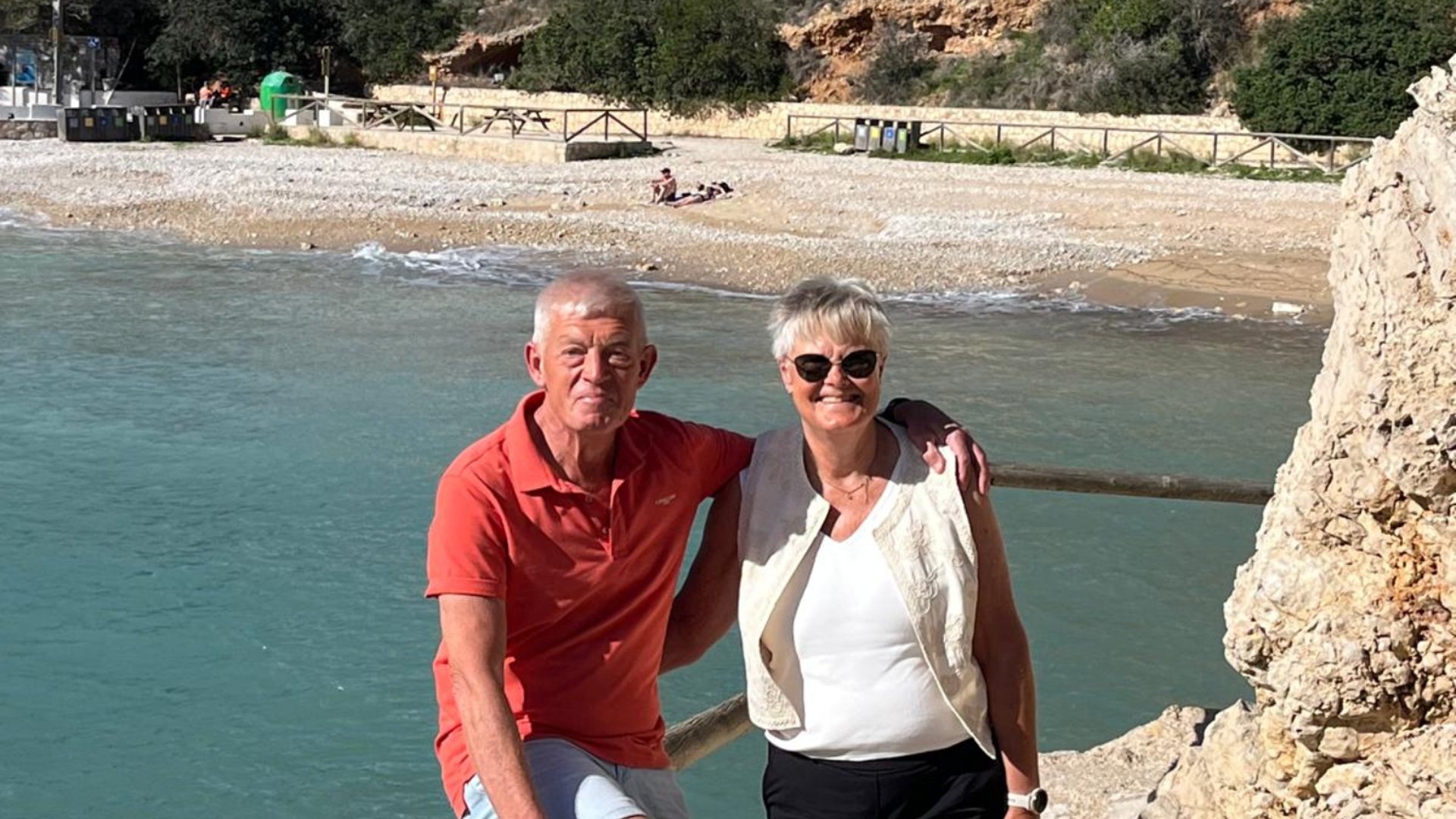Coastal path at Las Rotas in Dénia on the Costa Blanca North with a couple overlooking the Mediterranean Sea and rocky shoreline.